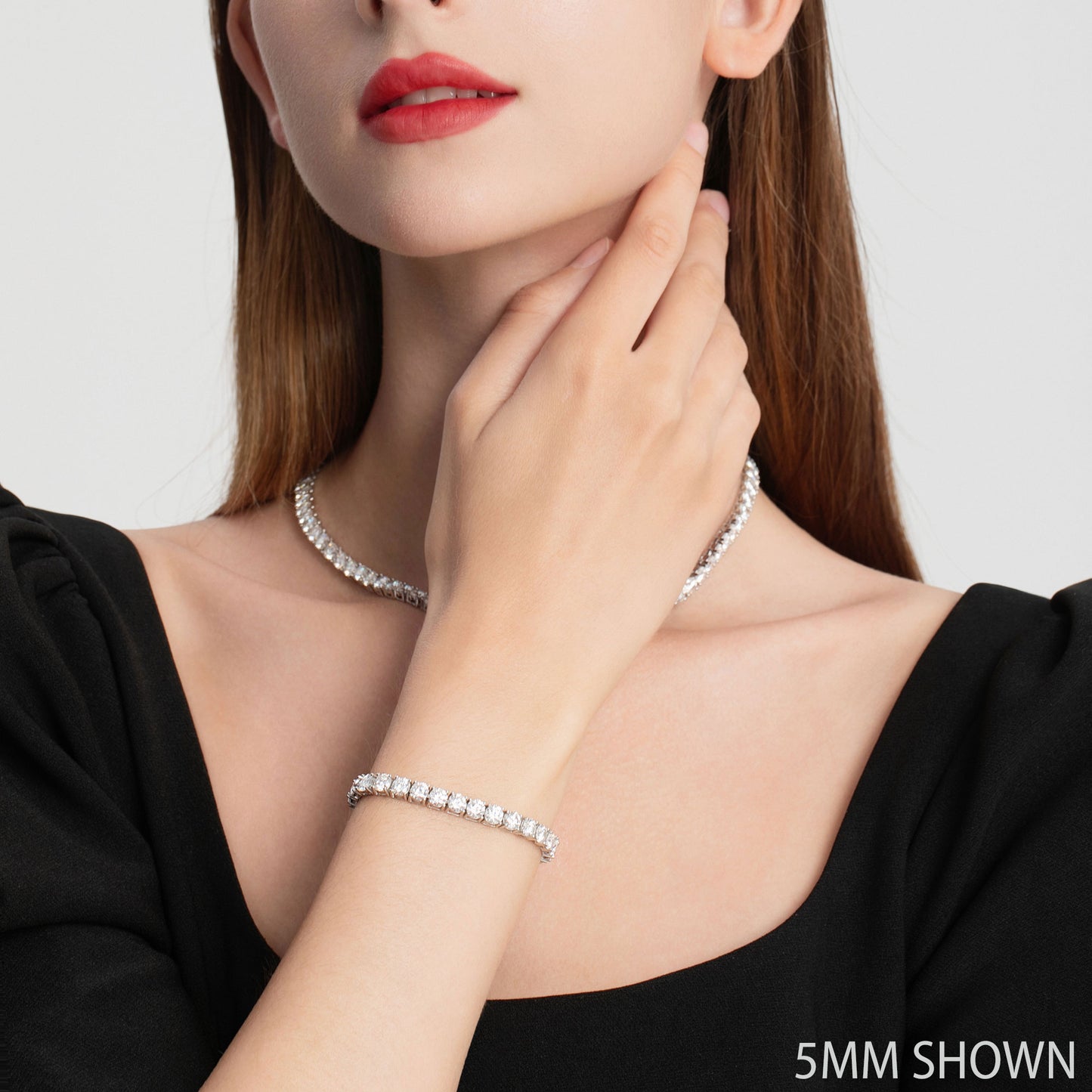 A woman wearing a 5mm moissanite tennis necklace and bracelet