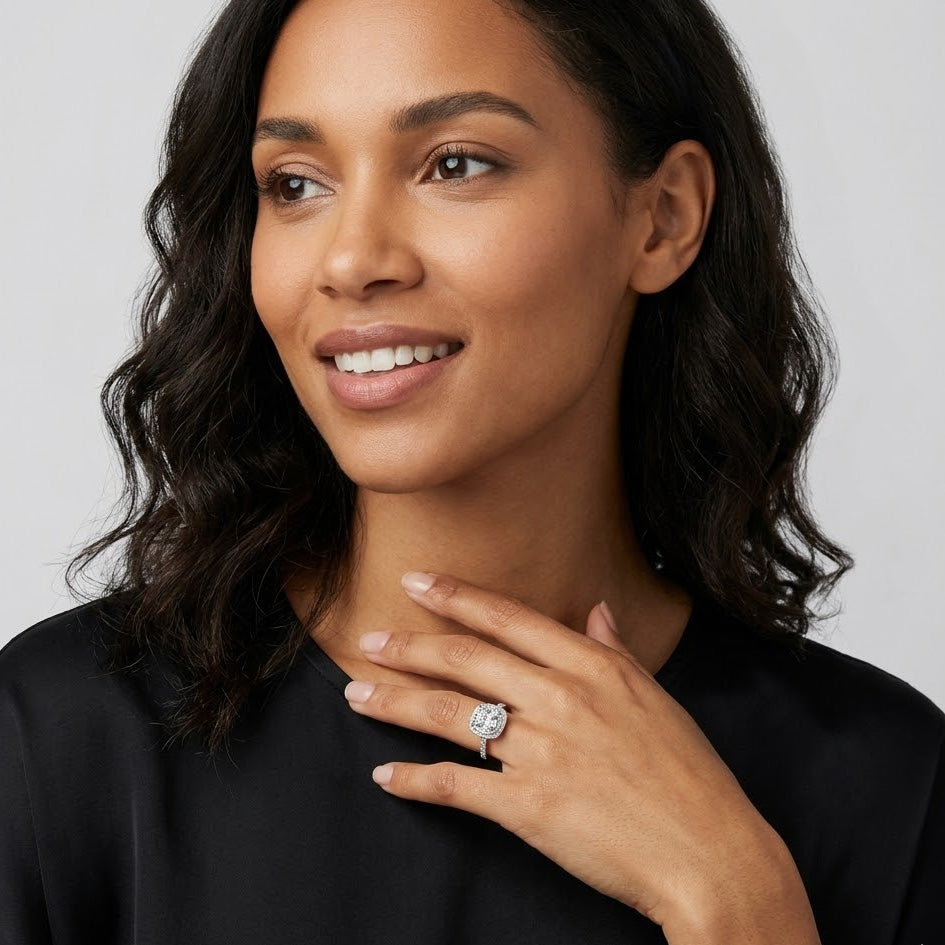 Woman wearing a diamond ring on a plain background