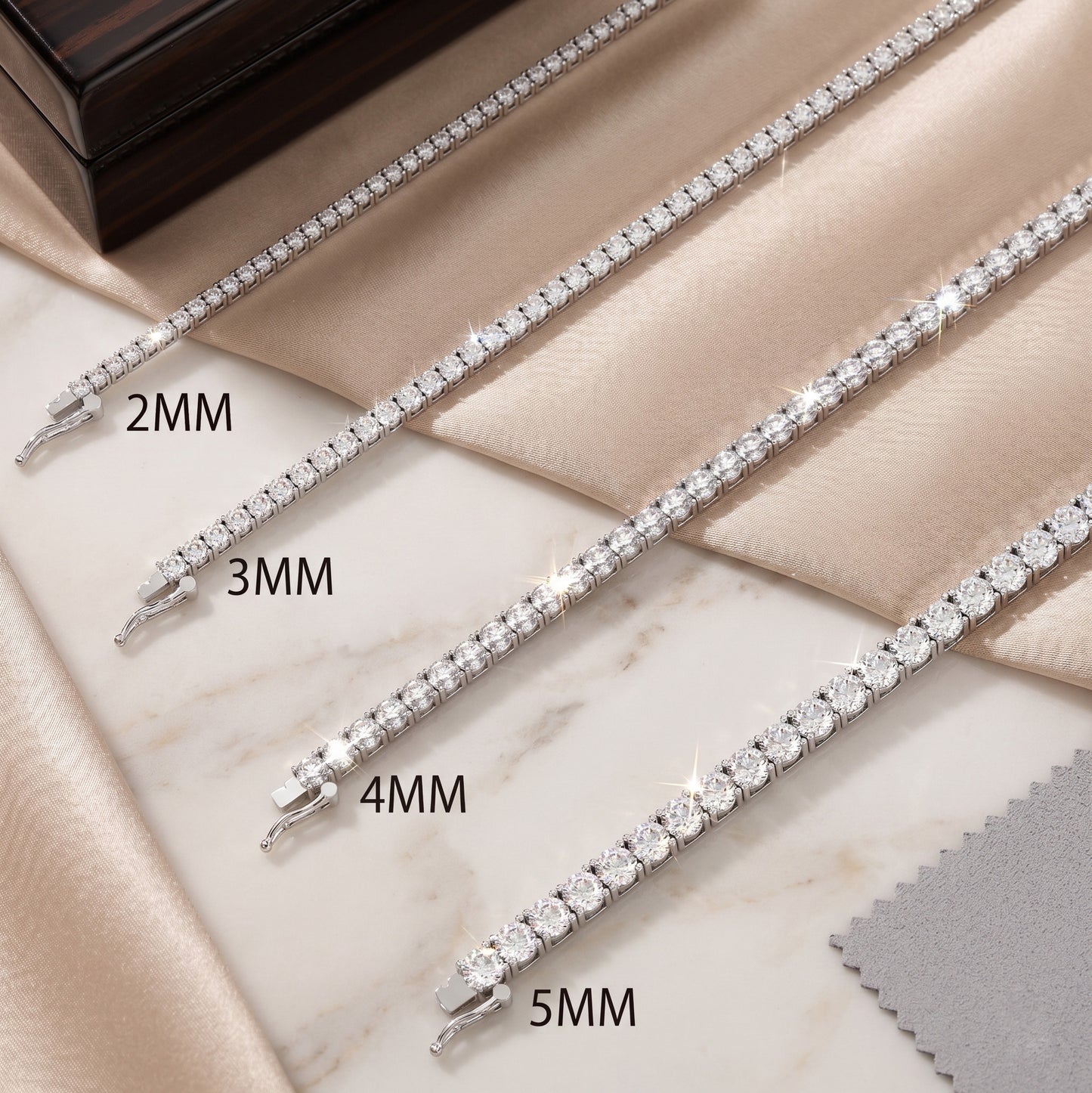 Silver bracelet with different width options on a marble surface